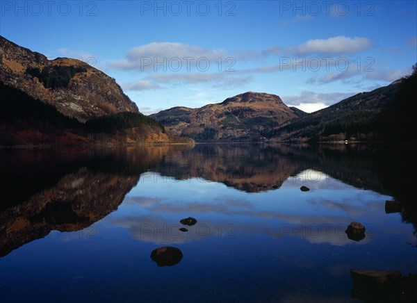Scotland, Argyll and Bute, Loch Lubnaig, Loch Lomand and Trossachs National Park. View north over Loch Lubnaig towards Meal Mor hill in centre at 1750 feet. Sky and clouds reflected in water. 
Photo : Bryan Pickering