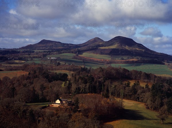 Scotland, Borders, Melrose, Eildon Hills circa 422 metres from Scotts View. Rooftops of house in foreground and agricultural land bordered by trees. 
Photo : Bryan Pickering