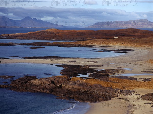 Scotland, Highlands, Ardnamurchan, Sanna Bay with from left to right the Isle of Rum and Isle of Eigg beyond. 
Photo : Bryan Pickering