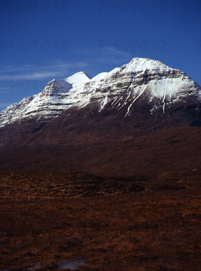 Scotland, Highlands, Torridon, View from Glen Torridon towards south east face of Liathach 1055 metres at highest point with snow topped summit. 
Photo : Bryan Pickering