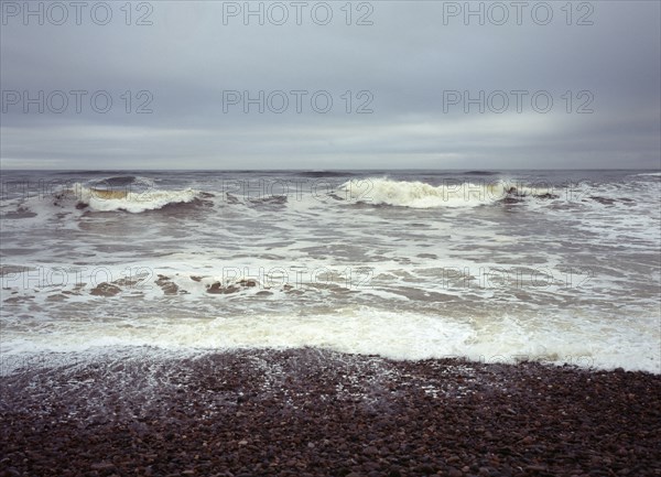 Scotland, Moray, Kingston, North facing shingle beach looking out across rough sea and surf. 
Photo : Bryan Pickering