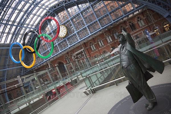 England, London, St Pancras railway station on Euston Road Statue of Sir John Betjeman. Olympic Games 2012 hanging sculpture. 
Photo : Stephen Rafferty