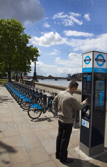 England, London, Vauxhall Albert Embankment of the river Thames man buying time on bicycle hire self service machine. 
Photo : Stephen Rafferty