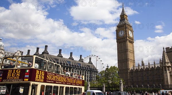 England, London, Westminster sight seeing bus with tourists passing by the Houses of Parliament Clock Tower better known as Big Ben. 
Photo : Stephen Rafferty