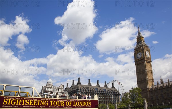 England, London, Westminster sight seeing bus with tourists passing by the Houses of Parliament Clock Tower better known as Big Ben. 
Photo : Stephen Rafferty