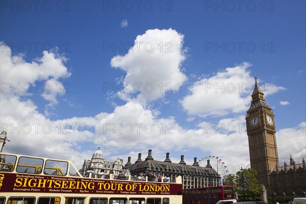 England, London, Westminster sight seeing bus with tourists passing by the Houses of Parliament Clock Tower better known as Big Ben. 
Photo : Stephen Rafferty