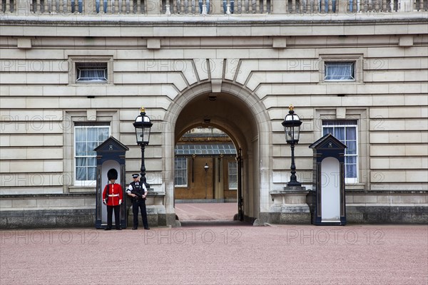 England, London, Westminster Buckingham Palace exterior with both Queens Guard and Metropolitan Police armed officers. 
Photo : Stephen Rafferty