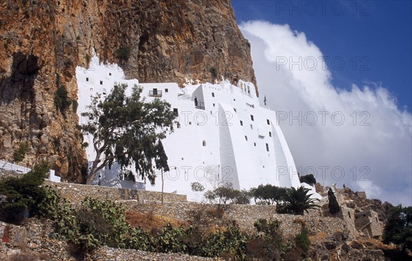 Greece, Aegean Islands, Amorgos, Moni Chozoviotissa. Exterior of white painted Byzantine monastery built above terraces on side of steep cliff. 
Photo : Mike Southern