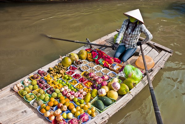 Vietnam, North, Markets, Floating market woman selling fruit & vegetables from a boat. 
Photo : Richard Rickard
