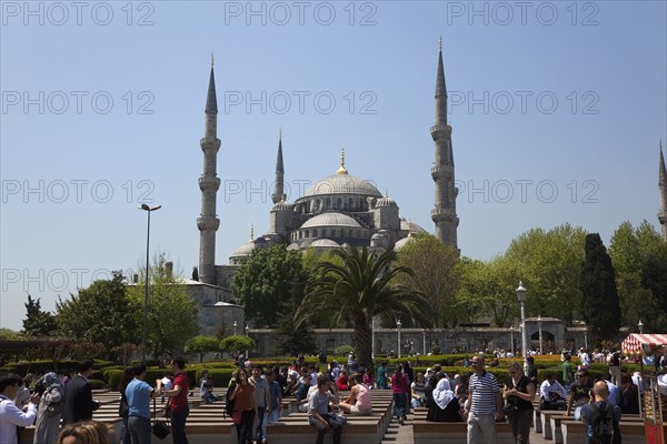 Turkey, Istanbul, Sultanahmet Camii Blue Mosque with tourists sat outside. 
Photo : Stephen Rafferty