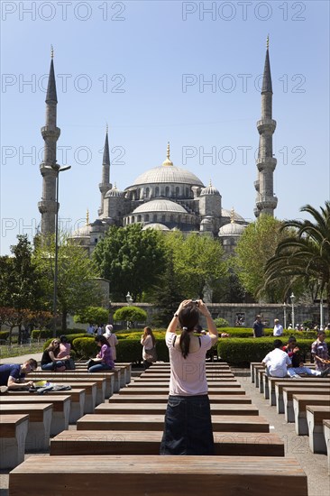 Turkey, Istanbul, Sultanahmet Camii Blue Mosque with tourist taking picture on her camera phone. 
Photo : Stephen Rafferty
