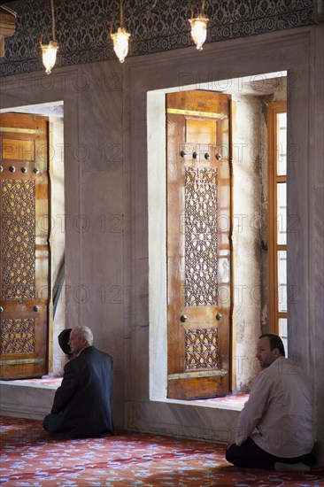 Turkey, Istanbul, Sultanahmet Camii Blue Mosque interior with men at worship. 
Photo : Stephen Rafferty