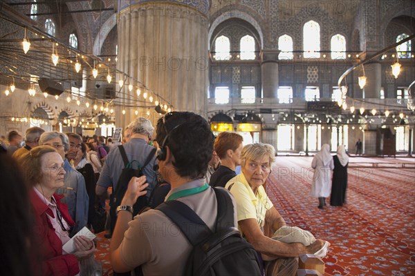 Turkey, Istanbul, Sultanahmet Camii Blue Mosque interior with guided tour group listening on headphones to guide. 
Photo : Stephen Rafferty