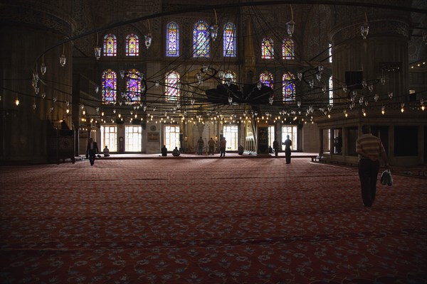 Turkey, Istanbul, Sultanahmet Camii Blue Mosque interior with men at worship. 
Photo : Stephen Rafferty