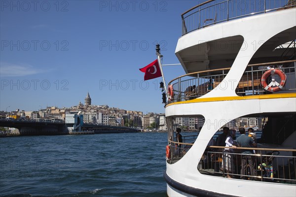 Turkey, Istanbul, Eminonu view across the Golden Horn toward Galata district. White ferry carrying passengers in foreground. 
Photo : Stephen Rafferty