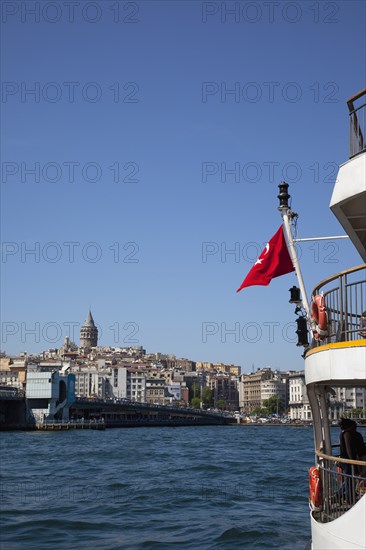 Turkey, Istanbul, Eminonu view across the Golden Horn toward Galata district. White ferry carrying passengers in foreground. 
Photo : Stephen Rafferty