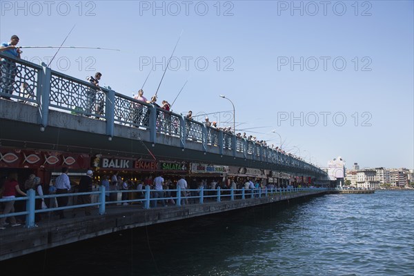 Turkey, Istanbul, Galata Bridge people fishing. 
Photo : Stephen Rafferty