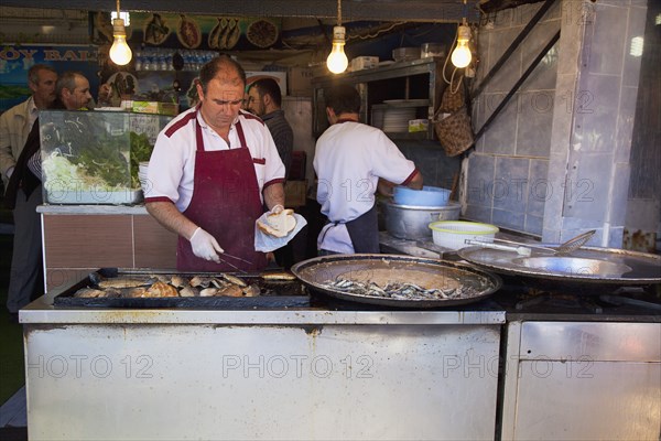 Turkey, Istanbul, Karakoy Galata fish market stall selling fried fish snacks. 
Photo : Stephen Rafferty