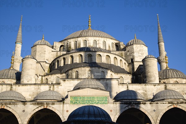 Turkey, Istanbul, Sultanahmet Camii The Blue Mosque domes seen from the Courtyard with Arabic text from the Koran. 
Photo : Paul Seheult