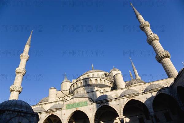 Turkey, Istanbul, Sultanahmet Camii The Blue Mosque domes seen from the Courtyard with Arabic text from the Koran. 
Photo : Paul Seheult