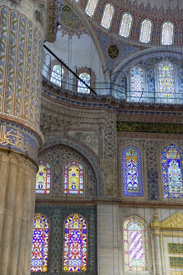 Turkey, Istanbul, Sultanahmet Camii The Blue Mosque interior with painted walls and stained glass windows. 
Photo : Paul Seheult
