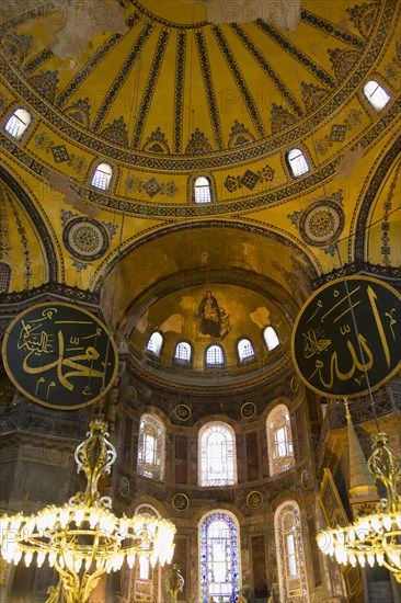 Turkey, Istanbul, Sultanahmet Haghia Sophia Christian murals and Muslim iconography in calligraphic roundels together in the domed interior. 
Photo : Paul Seheult