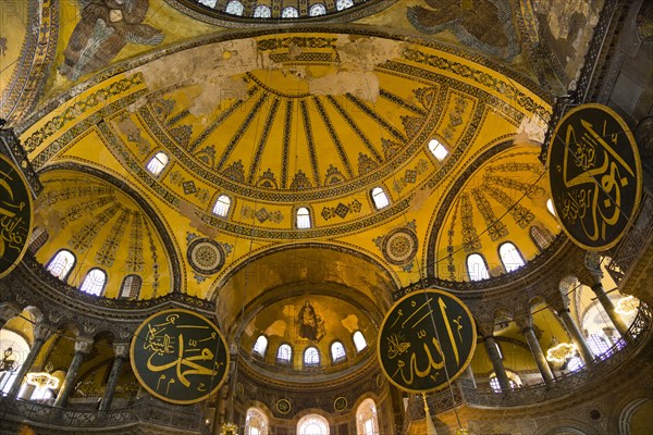 Turkey, Istanbul, Sultanahmet Haghia Sophia Christian murals and Muslim iconography in calligraphic roundels together in the domed interior. 
Photo : Paul Seheult