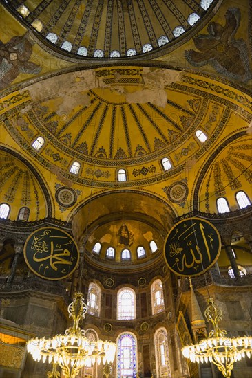 Turkey, Istanbul, Sultanahmet Haghia Sophia Christian murals and Muslim iconography in calligraphic roundels together in the domed interior. 
Photo : Paul Seheult