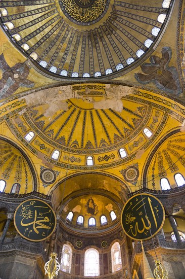 Turkey, Istanbul, Sultanahmet Haghia Sophia Christian murals and Muslim iconography in calligraphic roundels together in the domed interior. 
Photo : Paul Seheult