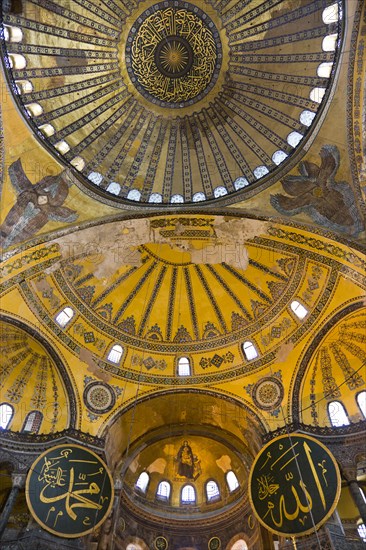 Turkey, Istanbul, Sultanahmet Haghia Sophia Christian murals and Muslim iconography in calligraphic roundels together in the domed interior. 
Photo : Paul Seheult