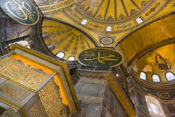 Turkey, Istanbul, Sultanahmet Haghia Sophia Christian murals and Muslim iconography in calligraphic roundels together in the domed interior. 
Photo : Paul Seheult