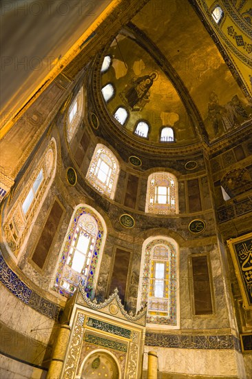 Turkey, Istanbul, Sultanahmet Haghia Sophia Christian mosaic of Virgin Mary and Infant Jesus and Muslim Mihrab indicating the direction of Mecca in a niche at the end of the nave. 
Photo : Paul Seheult