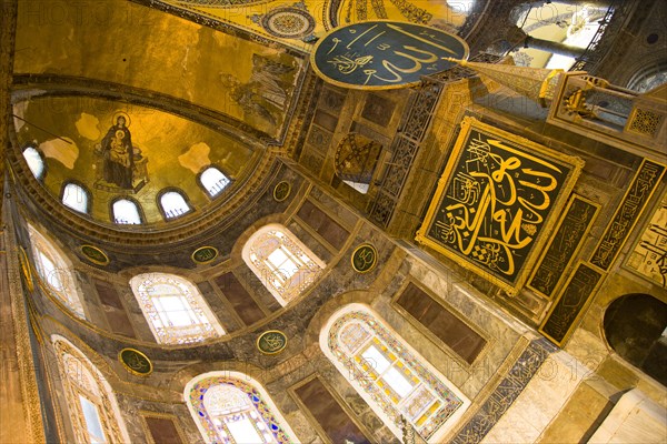 Turkey, Istanbul, Sultanahmet Haghia Sophia Christian murals and Muslim iconography in calligraphic roundels together in the domed interior. 
Photo : Paul Seheult