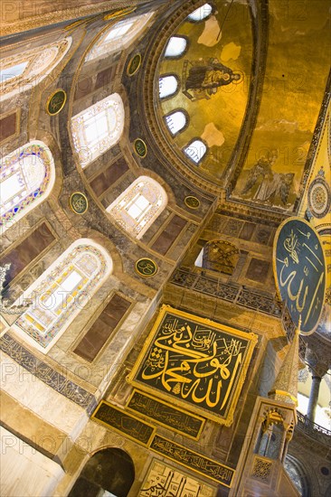 Turkey, Istanbul, Sultanahmet Haghia Sophia Christian murals and Muslim iconography in calligraphic roundels together in the domed interior. 
Photo : Paul Seheult