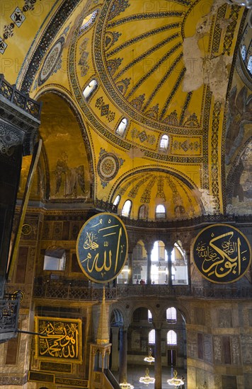 Turkey, Istanbul, Sultanahmet Haghia Sophia Christian murals and Muslim iconography in calligraphic roundels together in the domed interior. 
Photo : Paul Seheult