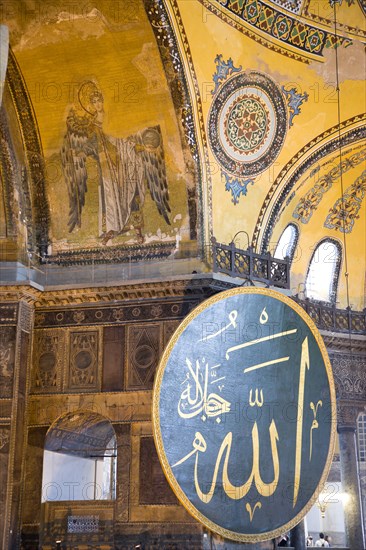 Turkey, Istanbul, Sultanahmet Haghia Sophia Christian murals and Muslim iconography in calligraphic roundels together in the domed interior. 
Photo : Paul Seheult