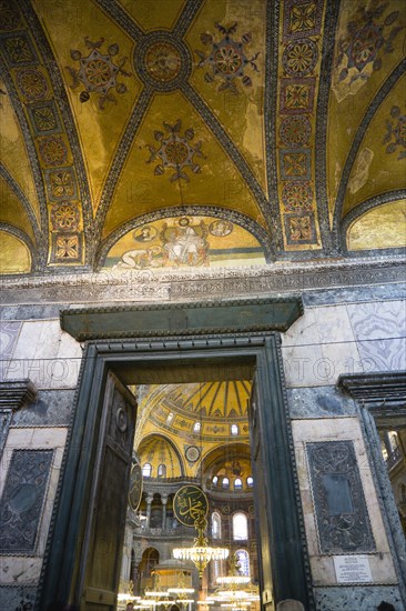 Turkey, Istanbul, Sultanahmet Haghia Sophia The Imperial Gate with mosaics above and the Nave of the Cathedral beyond. 
Photo : Paul Seheult