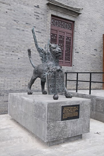 China, Jiangsu, Yangzhou, Bronze lion sculpture outside the Marco Polo Museum. The sculpture is a copy of the lion statue standing in a square in Venice the hometown of Marco Polo. Marco Polo served as a municipal official of Yangzhou from 1282-1287 during the reign of the Mongol emporor Kubilai Khan. 
Photo : Trevor Page