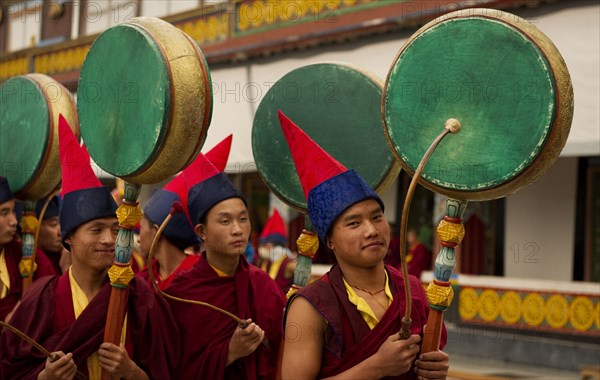 Buddhist Monks playing drums in a Losar ceremony, Sikkim, India