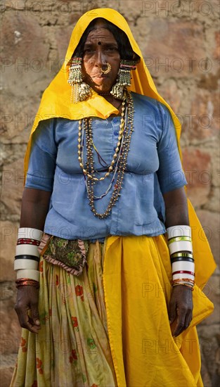 PORTRAIT OF A LAMBANI GYPSY TRIBAL WOMAN WITH TRADITIONAL TRIBAL JEWELRY AND COSTUME, INDIA. (MR)
