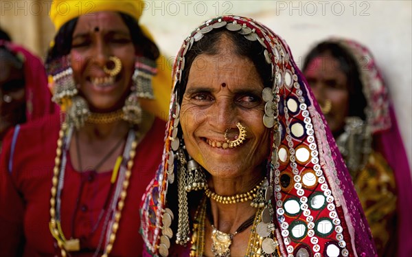 PORTRAIT OF A LAMBANI GYPSY TRIBAL WOMEN WITH TRADITIONAL TRIBAL JEWELRY AND COSTUME, INDIA. (MR)