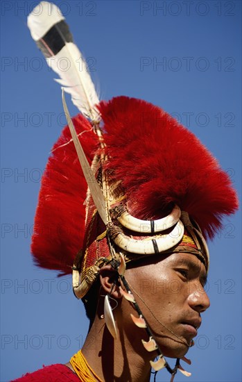 PORTRAIT OF A TRIBAL FROM A NAGA WARRIOR TRIBE WEARING TRADITIONAL COSTUME AND JEWELRY, NAGALAND, NORTH EAST INDIA