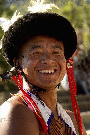 PORTRAIT OF A TRIBAL FROM A NAGA WARRIOR TRIBE WEARING TRADITIONAL COSTUME AND JEWELRY, NAGALAND, NORTH EAST INDIA