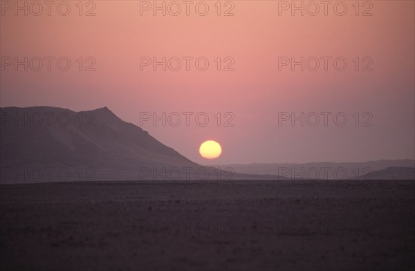 Namibia, Namib Naukluft National Park, Sunset in the Namib Naukluft desert. Access is restricted due to Diamond mining activity by DeBeers. 
Photo : Adrian Arbib