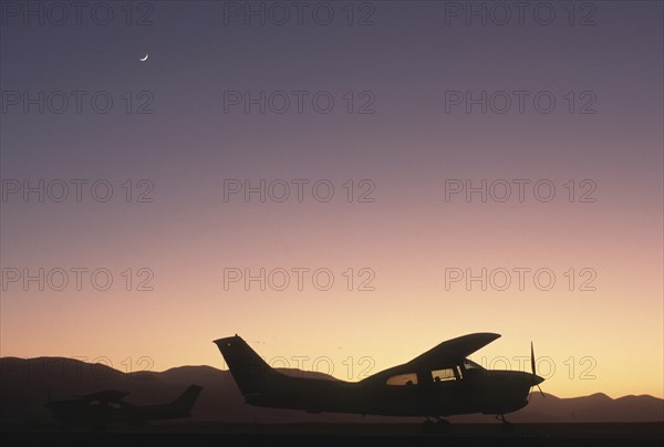 Namibia, North, Transport, A cessna aircraft in the desert silhouetted at sunset. 
Photo : Adrian Arbib