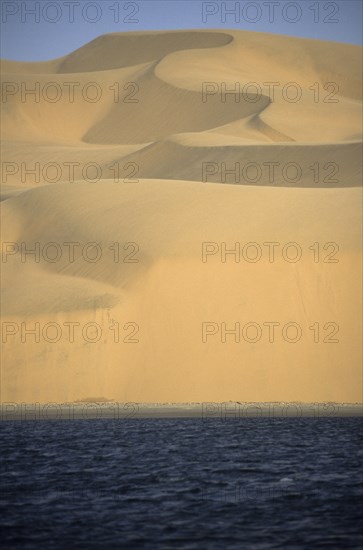 Namibia, Namib, Naukluft Desert, Sand dunes of the Langevaan a 1000 foot high wall of sand where the desert meets the Atlantic ocean. Access is restricted due to Diamond mining activity by DeBeers. 
Photo : Adrian Arbib