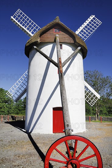 Ireland, County Roscommon, Elphin, Windmill. Painted white with red door. Built c.1730 and restored in 1996. Thatched rye rotating roof with four timber sails. 
Photo : Hugh Rooney