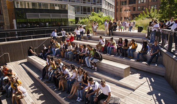 USA, New York, Manhattan, West Side High Line Park 10th Avenue Square Theater area with high school students sat waiting for performance. 
Photo : Jon Burbank