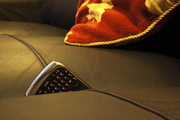 Communications, Telephones, Mobile, Phone stuck between cushions of leather sofa. 
Photo : Stephen Rafferty