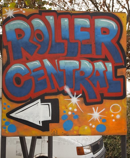 Art, Graffiti, Former parcel delivery warehouse converted into roller disco with the walls decorated by local graffiti artists. Sign pointing to entrance of Roller Central. 
Photo : Stephen Rafferty